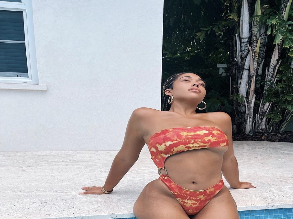 Jordyn Woods Seductively Poses in a Red Cut-Out Swimsuit